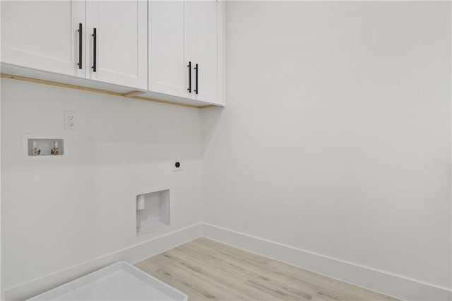 laundry room featuring washer hookup, cabinets, light wood-type flooring, and hookup for an electric dryer