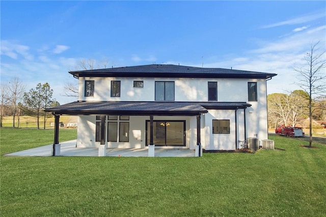 rear view of property with a patio area, central air condition unit, and a yard