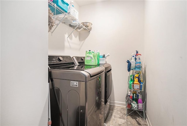 2909 Emme Ct, Conyers, GA 30094 - laundry area with separate washer and dryer, stone finish flooring, and baseboards