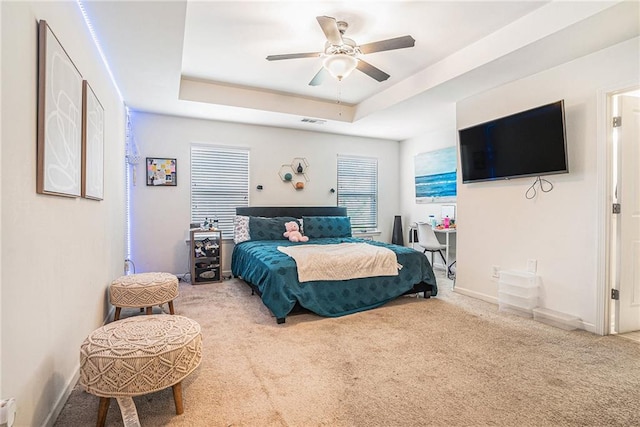 2909 Emme Ct, Conyers, GA 30094 - bedroom with carpet floors, a tray ceiling, baseboards, and a ceiling fan