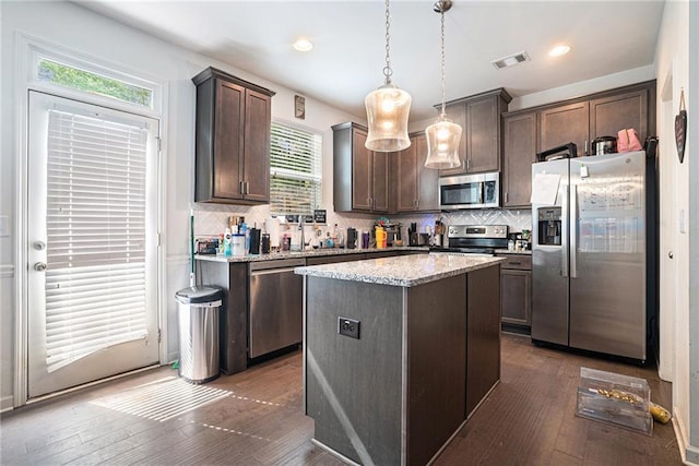 2909 Emme Ct, Conyers, GA 30094 - kitchen featuring stainless steel appliances, plenty of natural light, dark brown cabinetry, and recessed lighting