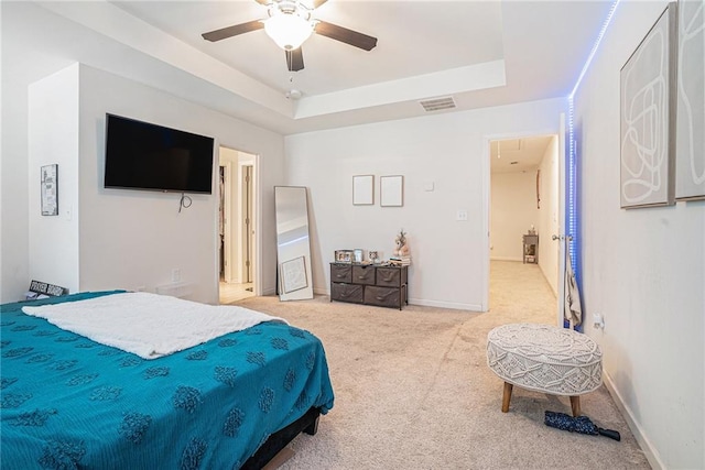 2909 Emme Ct, Conyers, GA 30094 - carpeted bedroom with a tray ceiling, a ceiling fan, and baseboards