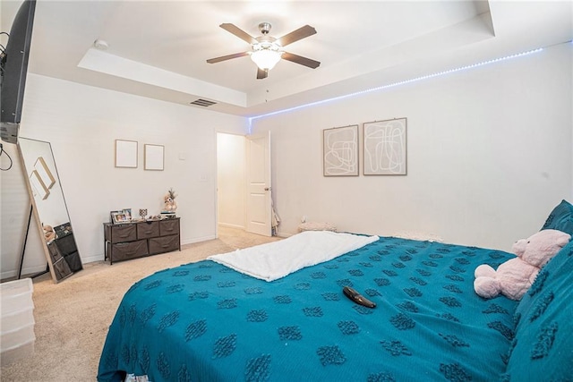 2909 Emme Ct, Conyers, GA 30094 - carpeted bedroom with a tray ceiling, a ceiling fan, and baseboards