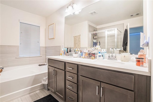 2909 Emme Ct, Conyers, GA 30094 - full bathroom with double vanity, a garden tub, and a stall shower