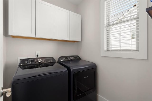 laundry area with cabinet space and independent washer and dryer