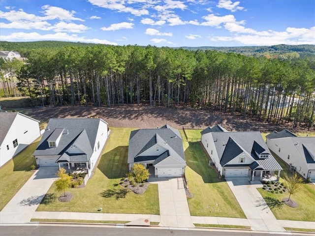 drone / aerial view with a residential view and a view of trees