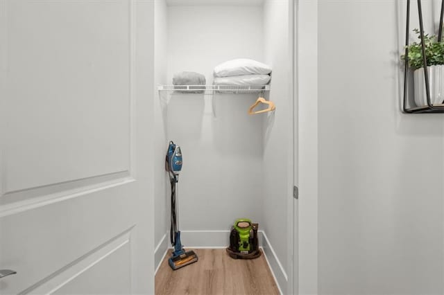 laundry area featuring hardwood / wood-style flooring