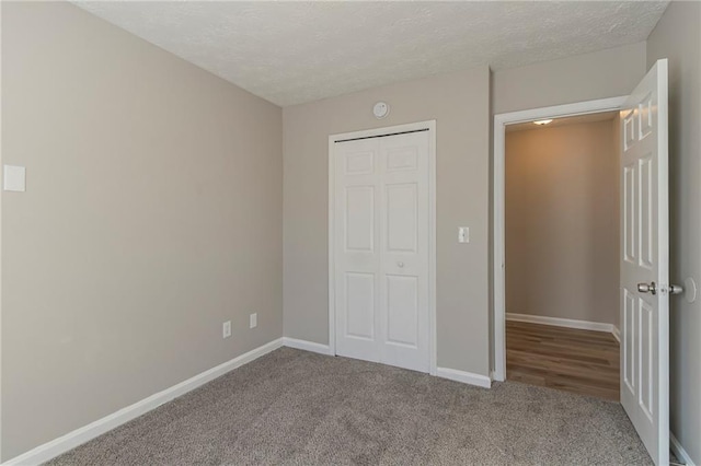 unfurnished bedroom with carpet floors and a textured ceiling