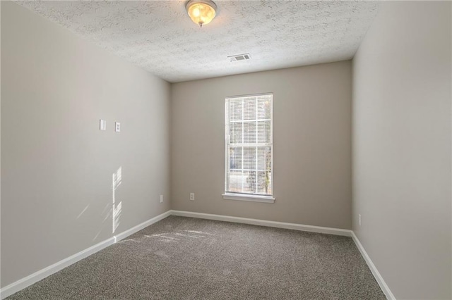 unfurnished room with carpet floors and a textured ceiling