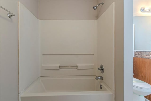 bathroom with toilet and shower / bathing tub combination