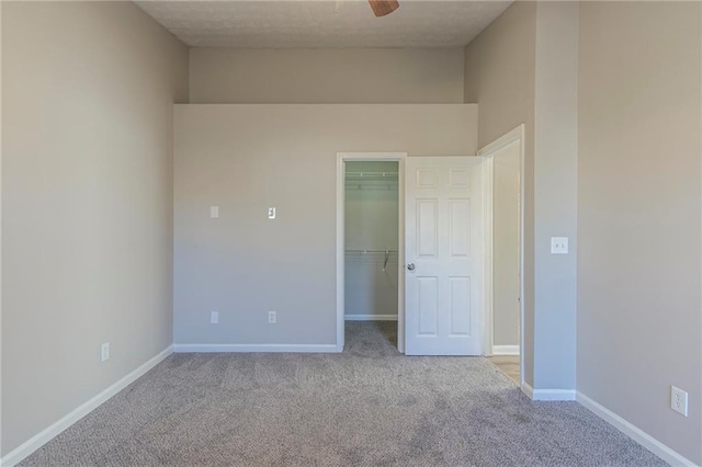 unfurnished room featuring light colored carpet and ceiling fan