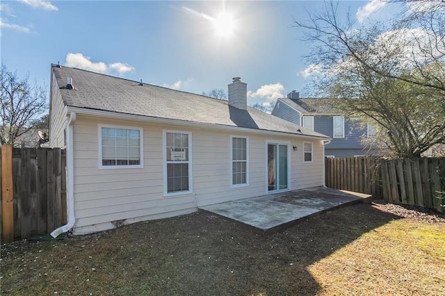 rear view of property with a lawn and a patio area