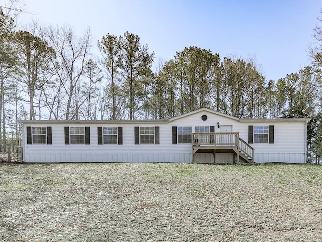 manufactured / mobile home featuring stairs and a wooden deck