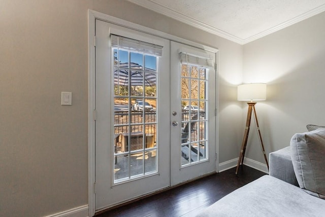 doorway featuring dark hardwood / wood-style floors, crown molding, and french doors