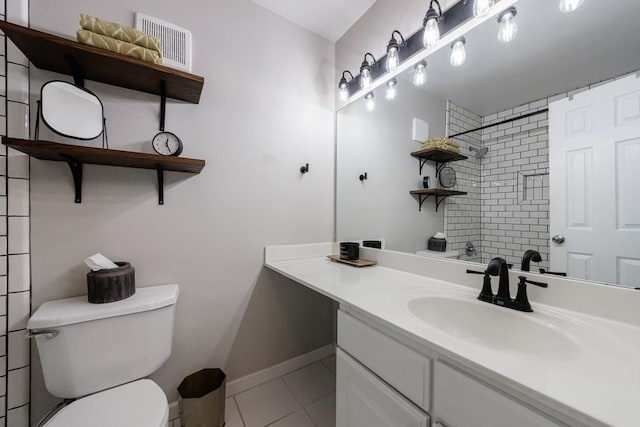 bathroom with vanity, toilet, and tile patterned floors