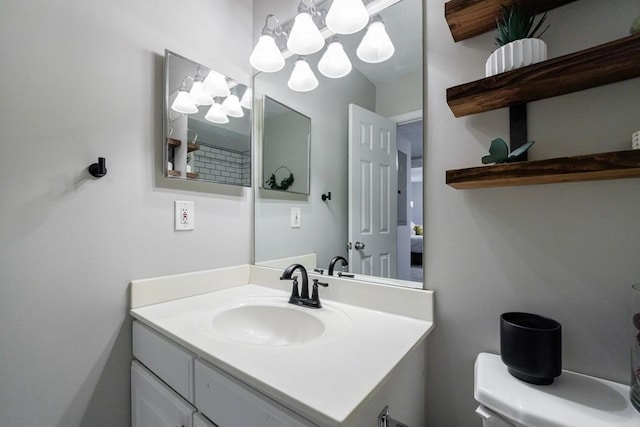 bathroom with toilet and vanity