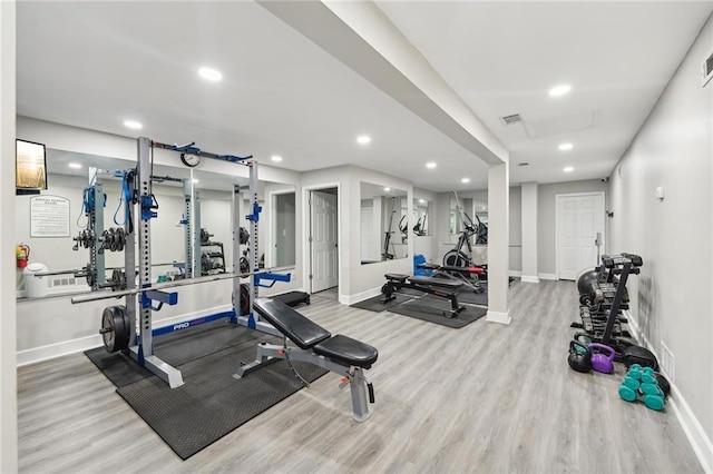 exercise room featuring light hardwood / wood-style flooring