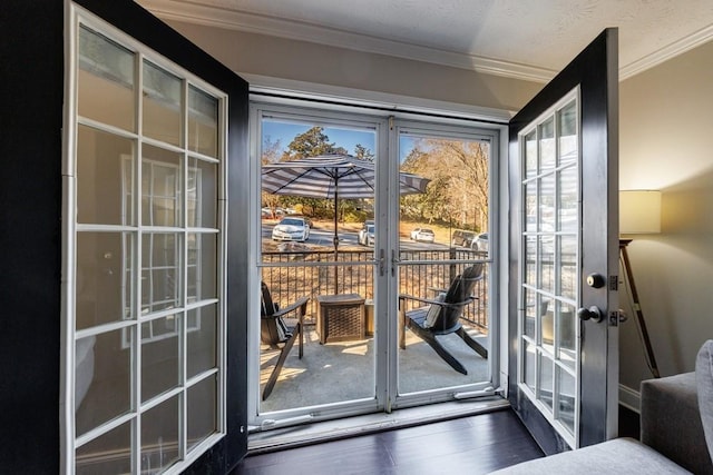 doorway featuring dark hardwood / wood-style floors, crown molding, and french doors