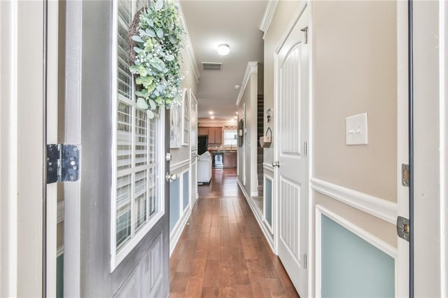 corridor with crown molding and dark wood-type flooring