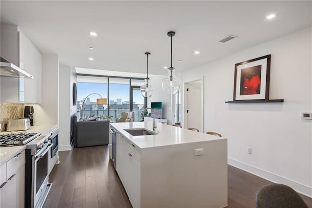 788 W Marietta St NW Unit 403, Atlanta, GA 30318 - kitchen with high end stove, dark wood-style floors, modern cabinets, white cabinetry, and recessed lighting