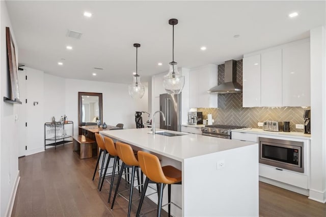 788 W Marietta St NW Unit 403, Atlanta, GA 30318 - kitchen featuring wall chimney exhaust hood, high end appliances, dark wood-style floors, white cabinets, and backsplash