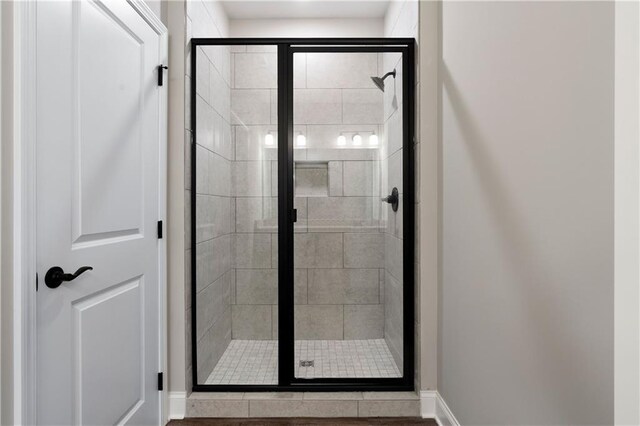 bathroom featuring a shower with shower door