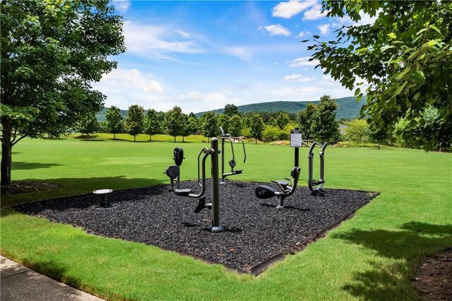 view of community with a lawn and a mountain view