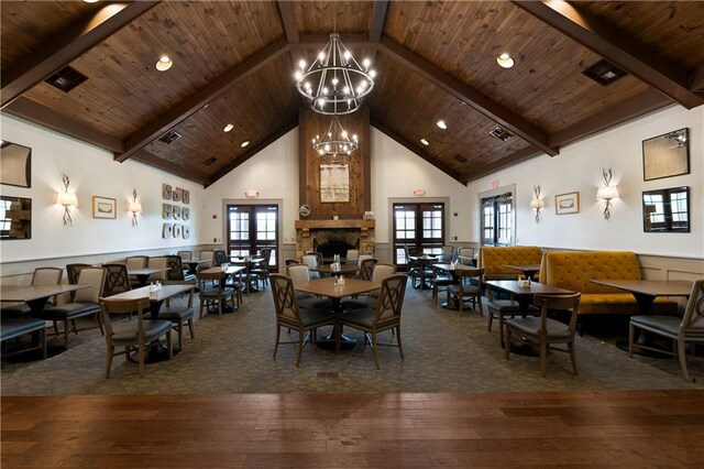 dining area featuring a wealth of natural light, high vaulted ceiling, wooden ceiling, and dark hardwood / wood-style floors