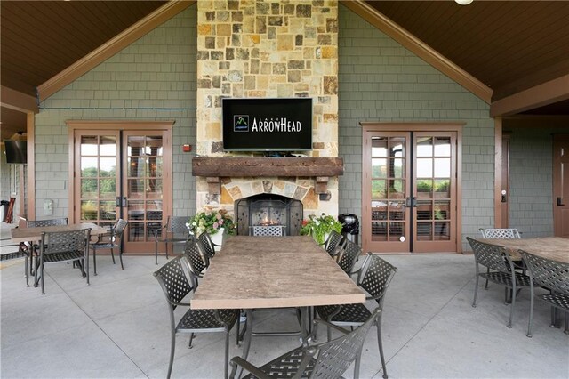 dining area featuring a wealth of natural light, french doors, and wooden ceiling