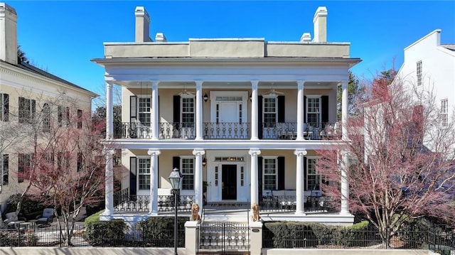 view of front facade with a balcony and covered porch