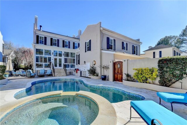 view of swimming pool featuring an in ground hot tub and a patio