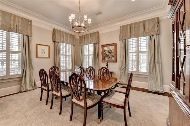 dining area with ornamental molding, plenty of natural light, and a notable chandelier