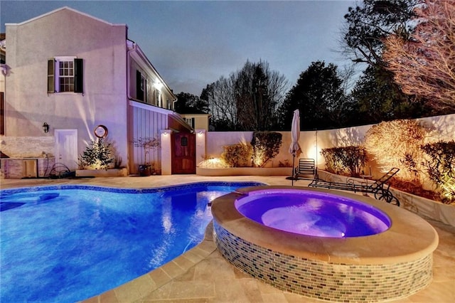 view of pool with a patio area and an in ground hot tub