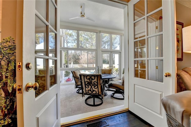 sunroom / solarium featuring ceiling fan and french doors