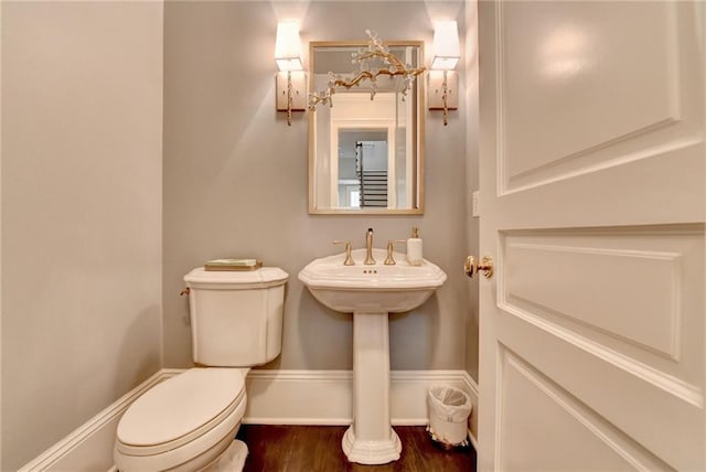 bathroom with wood-type flooring and toilet