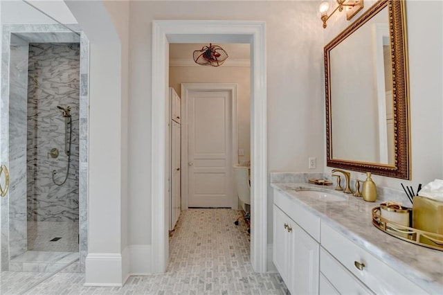 bathroom with vanity, tiled shower, and crown molding