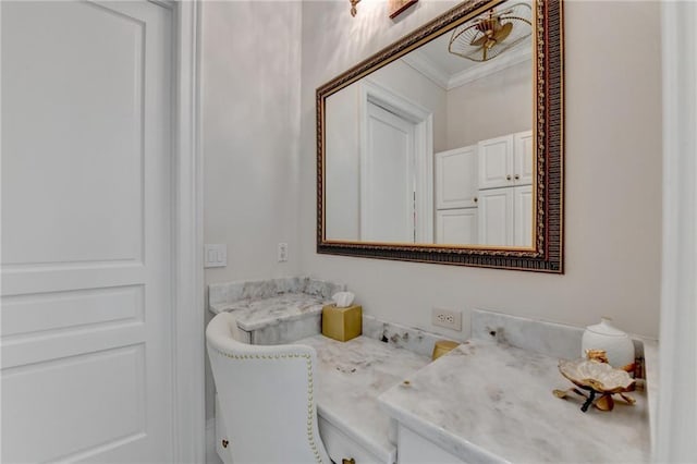 bathroom featuring crown molding and vanity