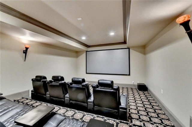 home theater room with crown molding and a tray ceiling