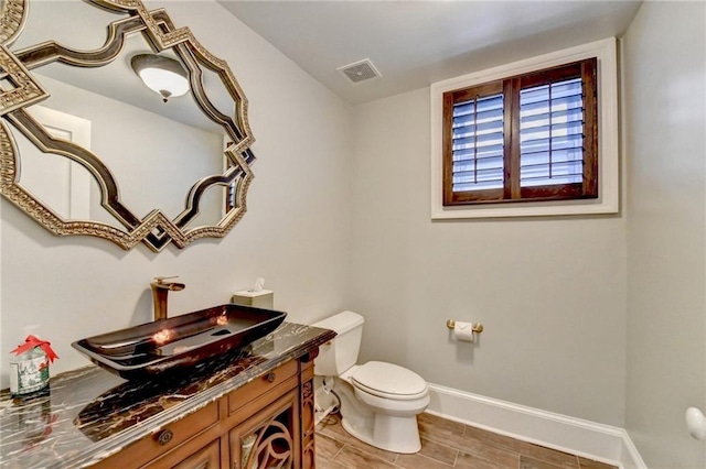 bathroom featuring vanity and toilet