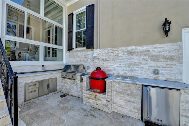 view of patio / terrace with an outdoor kitchen and a grill