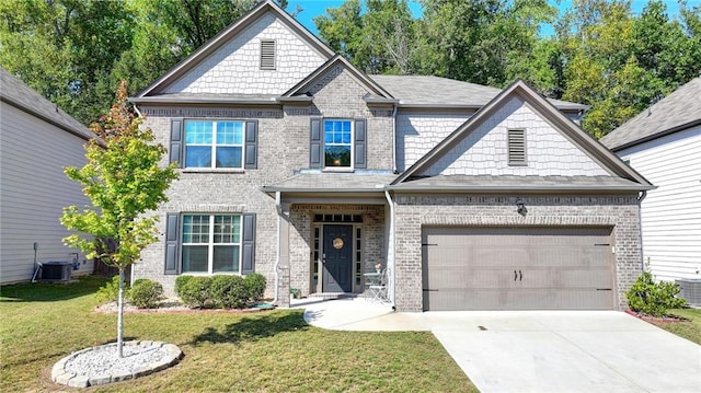 craftsman-style house featuring a garage, a front yard, and central air condition unit