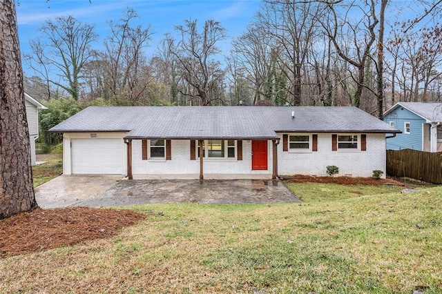 ranch-style house featuring brick siding, fence, a front yard, driveway, and an attached garage