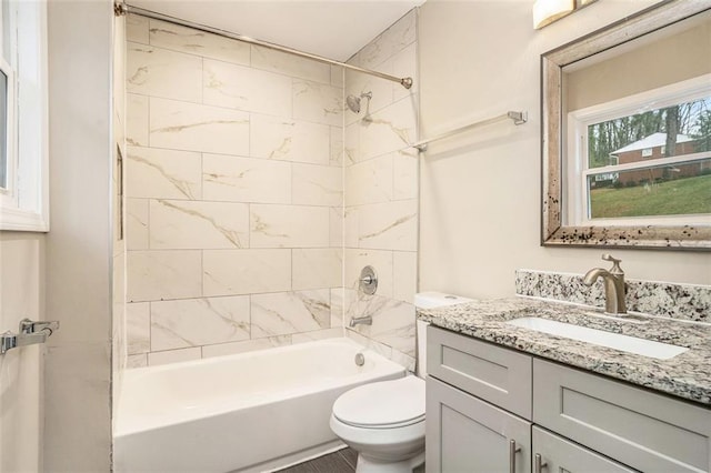 bathroom featuring vanity, bathing tub / shower combination, and toilet