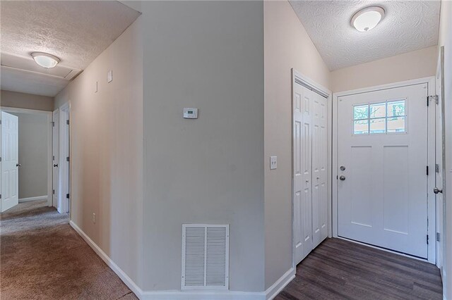 entryway with a textured ceiling and baseboards