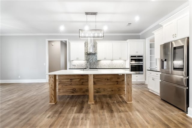 kitchen with sink, white cabinetry, stainless steel appliances, and an island with sink