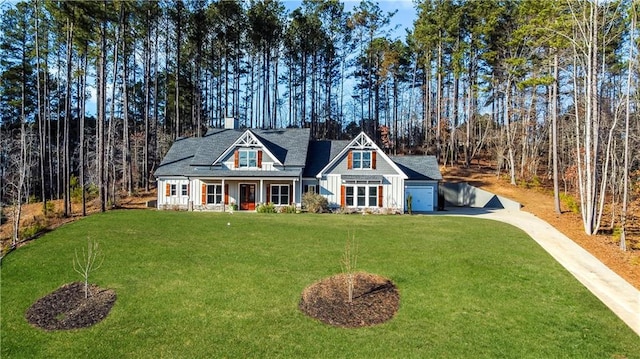 view of front of home with a front yard and covered porch