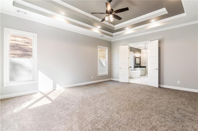 unfurnished bedroom featuring a raised ceiling, crown molding, ceiling fan, and light colored carpet