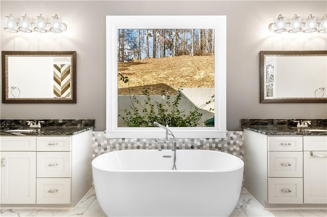 bathroom featuring vanity and a tub