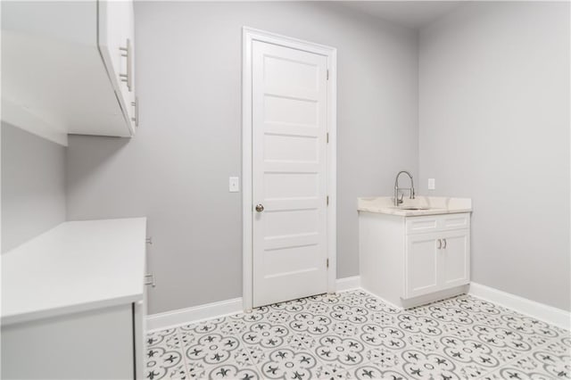 clothes washing area featuring sink