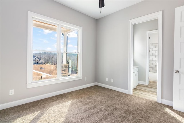 empty room with light carpet and ceiling fan